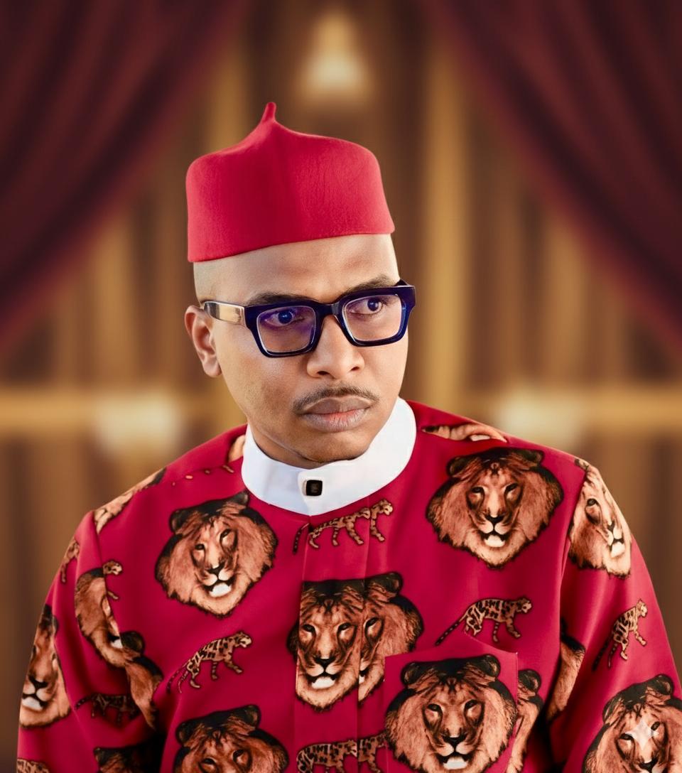 Dr. Ezulike in traditional Igbo attire with red cap